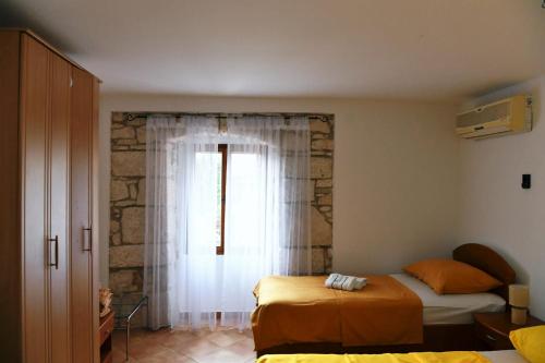 a bedroom with two beds and a window at Freya's Apartments Medulin in Medulin