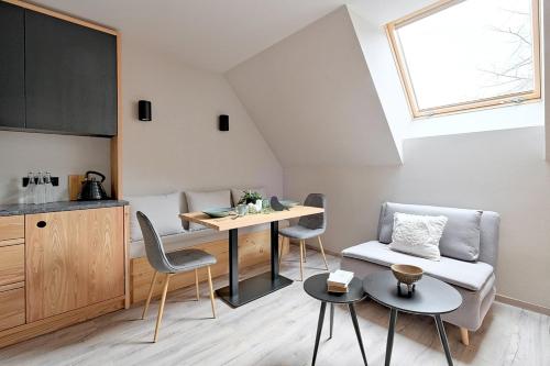 a kitchen and living room with a table and chairs at Harda House Friends & Spa in Zakopane