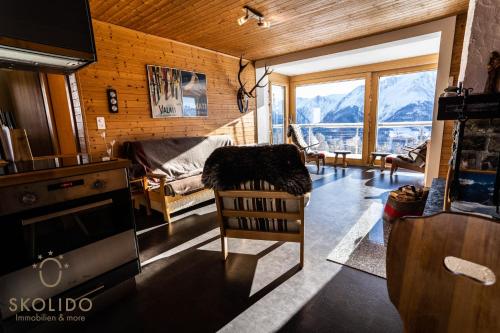 a living room with a view of a mountain at Chalet Lärchenwinkel, Riederalp Golmenegg in Riederalp