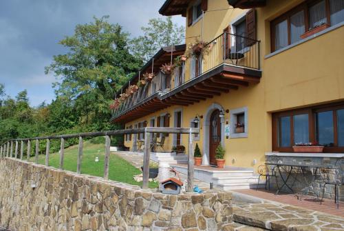 a yellow building with a fire hydrant next to a wall at Ciase dal Orcul in Cormòns