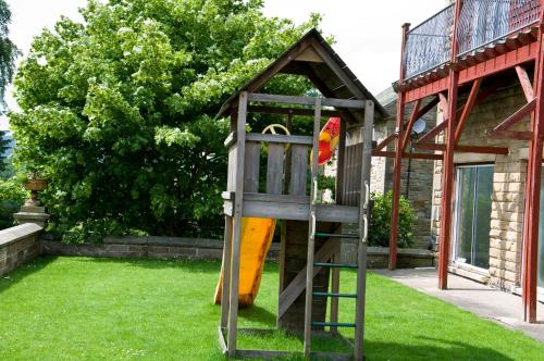 a play structure with a slide in a yard at Riverdale Hall Hotel & Leisure in Bellingham