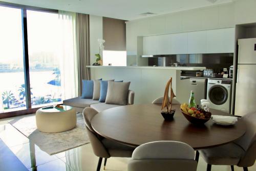 a kitchen and living room with a table and chairs at Fairmont Bab Al Bahr in Abu Dhabi
