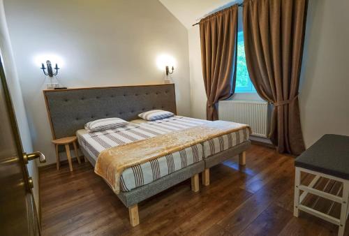 a bedroom with a bed and a large window at Apartament 2 camere - Casa Divertis in Buzău