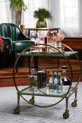 a glass table with bottles and glasses on it at Kimpton Clocktower by IHG in Manchester