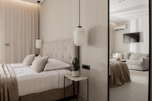 a bedroom with a bed and a living room at ALFA LUXURY APARTMENTS in Tsilivi