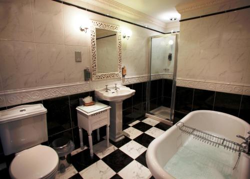 uma casa de banho com um WC, um lavatório e uma banheira em Riverdale Hall Hotel & Leisure em Bellingham