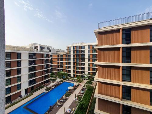 an aerial view of a building with a swimming pool at Brand new 1 bedroom apartment Dubai Hills 601 in Dubai