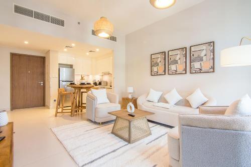 a living room with a couch and a table at Brand new 1 bedroom apartment Dubai Hills 601 in Dubai