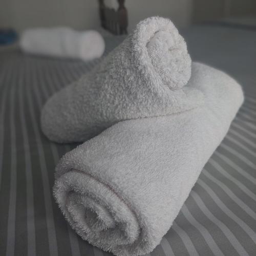a white towel sitting on top of a bed at Apartman Tadeus in Soko Banja