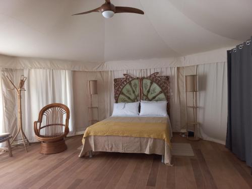 a bedroom with a bed and a ceiling fan at HMO Glamping & Suites in Vignanotica in Mattinata