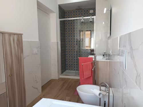 a bathroom with a sink and a toilet and a shower at Appartamento Cavaliere Tropea in Tropea