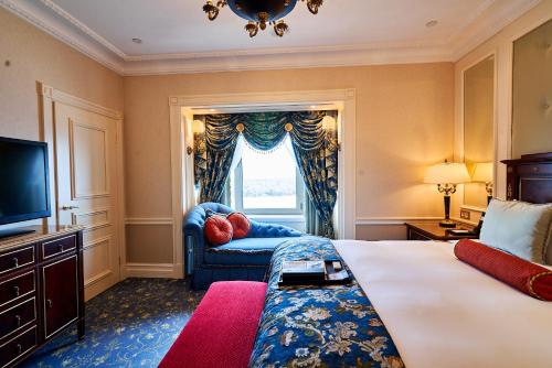 a hotel room with a large bed and a window at Fairmont Grand Hotel Kyiv in Kyiv