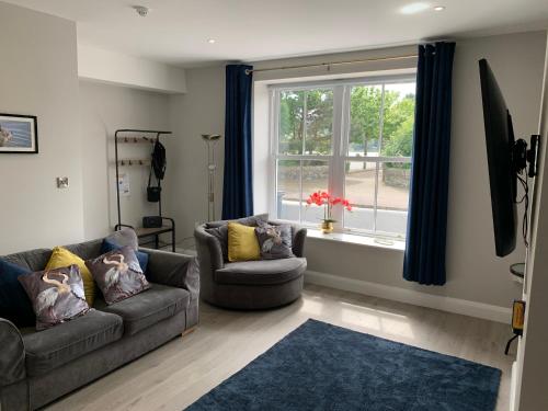 a living room with two couches and a window at Seaview Aurora House - Central Luxury Apartment in Warrenpoint
