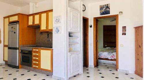 a kitchen with a door open to a bedroom at Maya Powered by SolymarCalma in Costa Calma