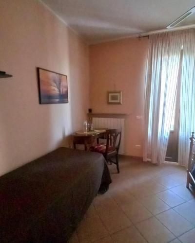 a bedroom with a table and a bed and a dining room at Il Girasole in Strevi