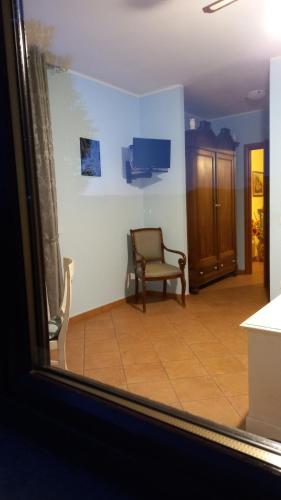 a living room with a chair and a window at Il Girasole in Strevi