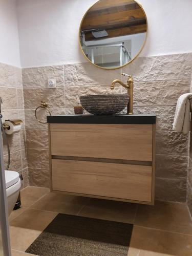 a bathroom with a sink and a mirror at Finca Eva 34 Casares Historico in Casares