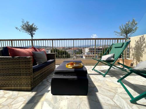 a patio with a couch and chairs on a balcony at RoofTop Apartement - Quartier Croisette in Cannes