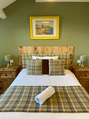 a bedroom with a bed with a blanket and pillows at Number 19 Guest House in Barrow in Furness