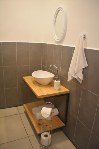 a bathroom with a sink and a mirror at El Salvador Surf Houses in Playa San Blas