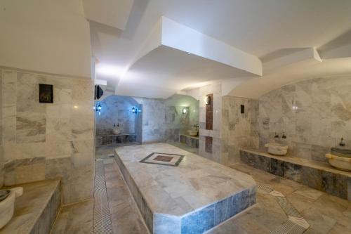 a large bathroom with two sinks and two toilets at Riva Bodrum Resort- Adult Only +16 in Gümbet