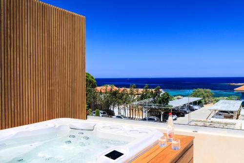 a bath tub with a view of the ocean at RESIDENCE SANTA MARIA in LʼÎle-Rousse