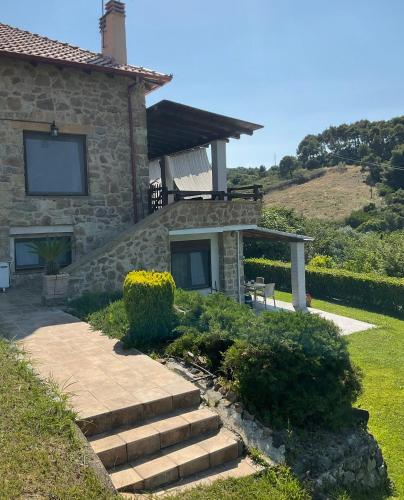 a stone house with stairs leading to a porch at STONEHOUSE & CASA AL SOLE e AL MARE in Nea Roda