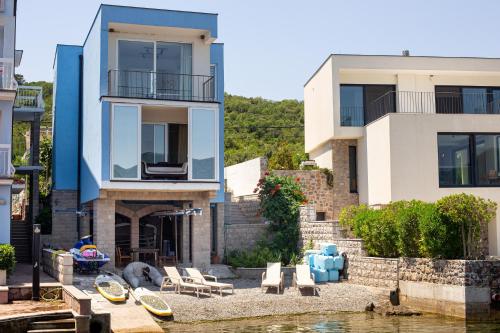 a house next to a body of water at Aquamarine House in Tivat