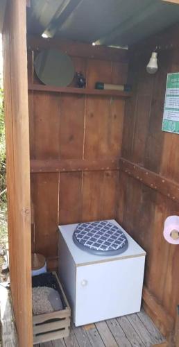 a outhouse with a mattress in the inside of it at Les Gîtes du Hameau avec piscine in Castelnau-sur-Gupie