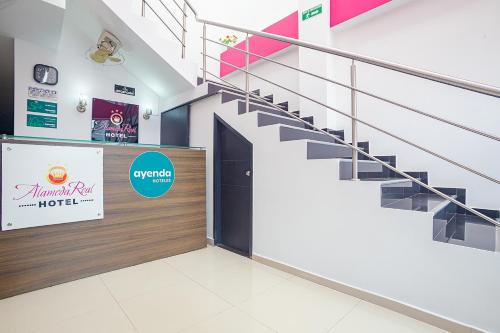 a set of stairs in a store with a sign at Ayenda Alameda Real in Montería