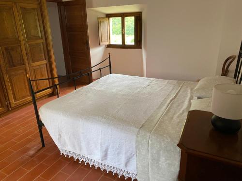 a bedroom with a bed with a white comforter at Torre Cavina in Palazzuolo sul Senio