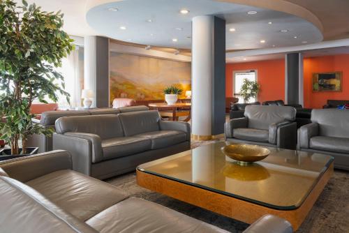 a living room with couches and a table at Perugia Park Hotel in Perugia