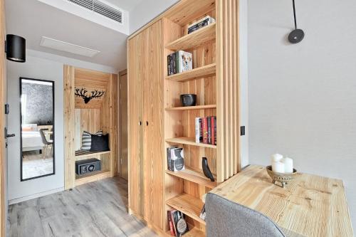 a room with a table and a book shelf at Harda House Friends & Spa in Zakopane