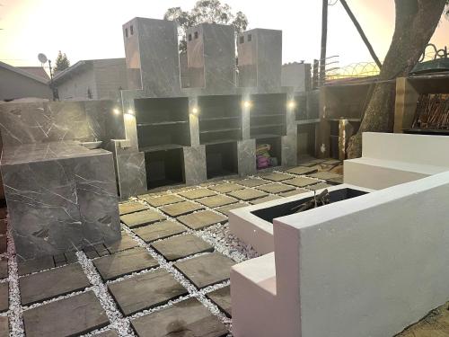 a stone wall with lights on top of it at Semeni Asante Guesthouse in Johannesburg