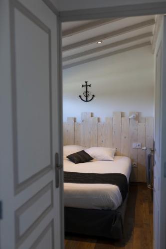 a bedroom with a bed with a wooden headboard at Logis Le Nid du Pont de Gau in Saintes-Maries-de-la-Mer