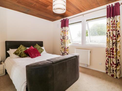 a bedroom with a bed and a large window at Lodge 27 in Bideford