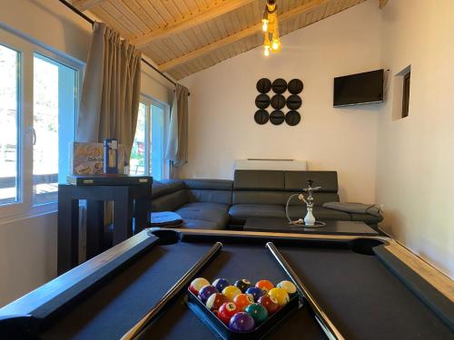 a living room with a pool table and a couch at Roua Bucovinei in Sadova