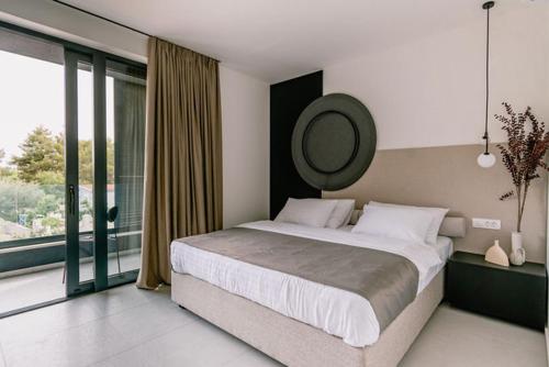 a bedroom with a large bed and a large window at Villa Casa Domina in Srima