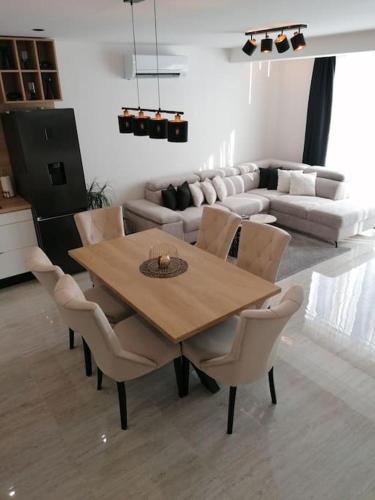 a wooden table and chairs in a living room at APARTMAN MAX !!!! in Omiš