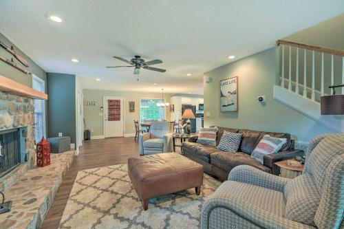 a living room with a couch and a fireplace at Lakefront Home with Entertainment Space and Dock! in Eatonton