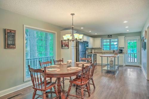 a kitchen and dining room with a table and chairs at Lakefront Home with Entertainment Space and Dock! in Eatonton