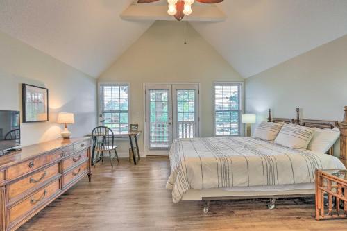 a bedroom with a bed and a table and chairs at Lakefront Home with Entertainment Space and Dock! in Eatonton
