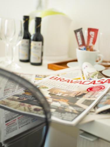 a table with a newspaper and bottles of wine at Centar Forever in Belgrade