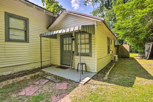 a yellow house with a door and a porch at Quaint Leeds Studio with Yard about 18 Mi to Birmingham! in Leeds