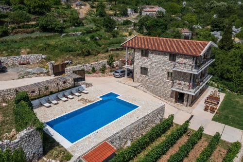 an aerial view of a house with a swimming pool at Apartments and Winery Djukovic in Virpazar