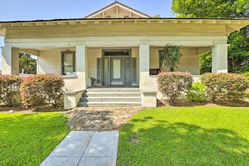 a house with a blue door and a grass yard at Quaint Leeds Studio with Yard about 18 Mi to Birmingham! in Leeds