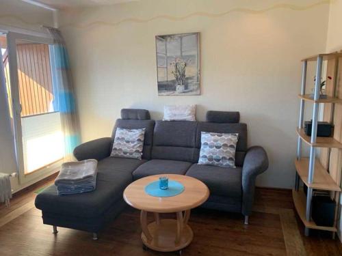 a living room with a couch and a table at Haus Gorch Fock in Neuharlingersiel