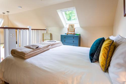 a large white bed in a room with a window at Cruickshanks Boutique B&B in Whiting Bay