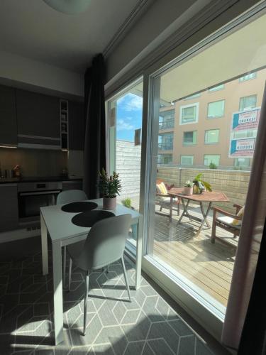 a kitchen and dining room with a large sliding glass door at The Seabreeze Apartment Turku in Turku