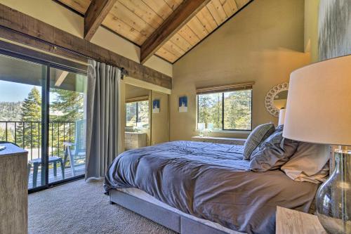 a bedroom with a bed and a large window at Alpine Meadows Condo with Mtn Views Near Lake Tahoe in Alpine Meadows